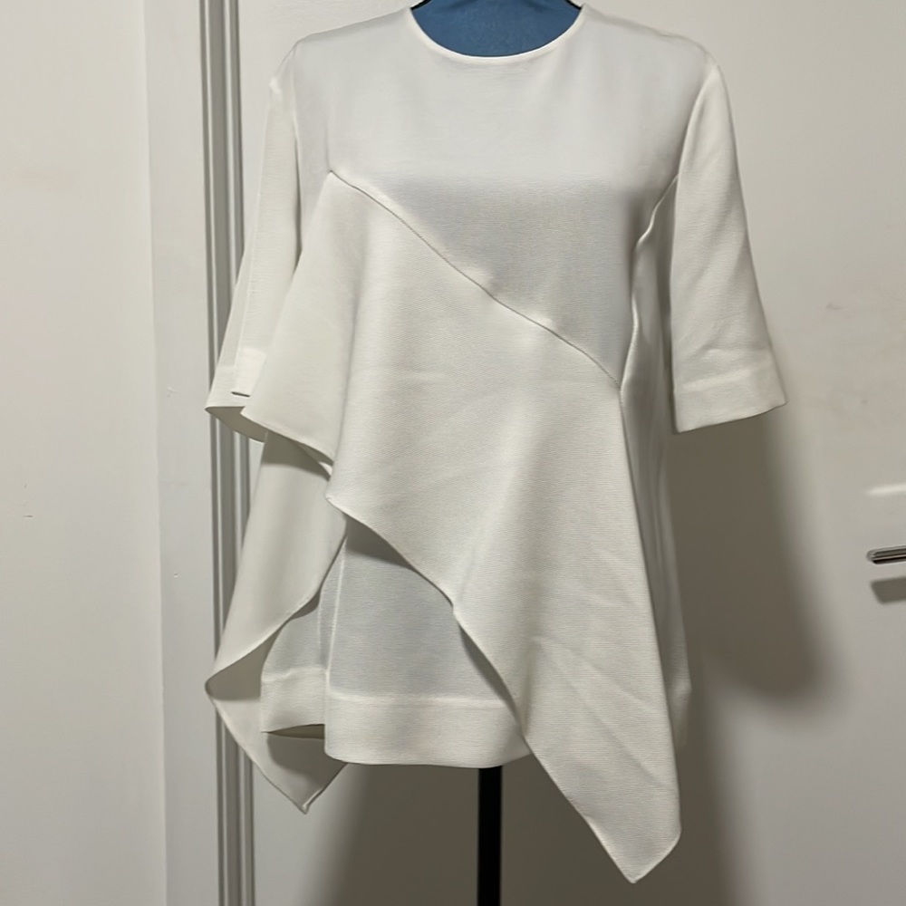 Diane von furstenberg beige blouse with asymmetrical design.